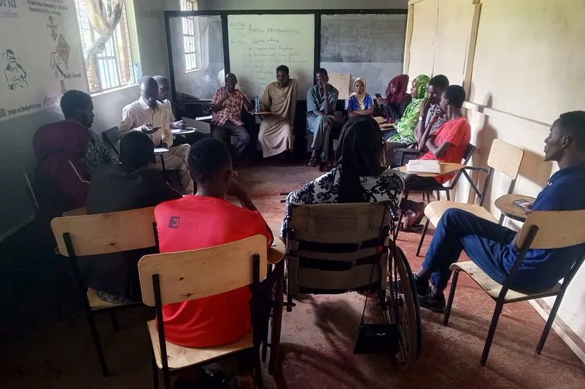 Inclusive community dialogue circle including a participant using a wheelchair
